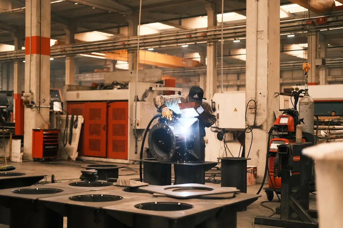 Factory worker welding a piece of metal